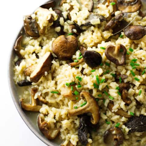 Over head photo of a bowl, spoon and mushroom risotto