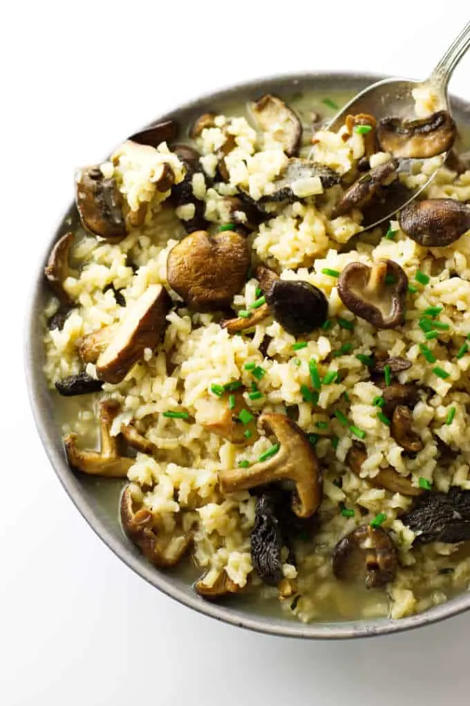 Over head photo of a bowl, spoon and mushroom risotto