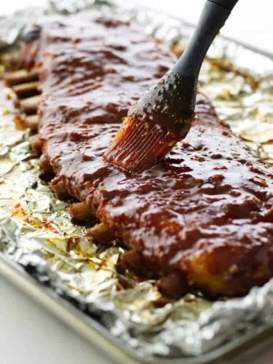 Pork ribs being brushed with glaze