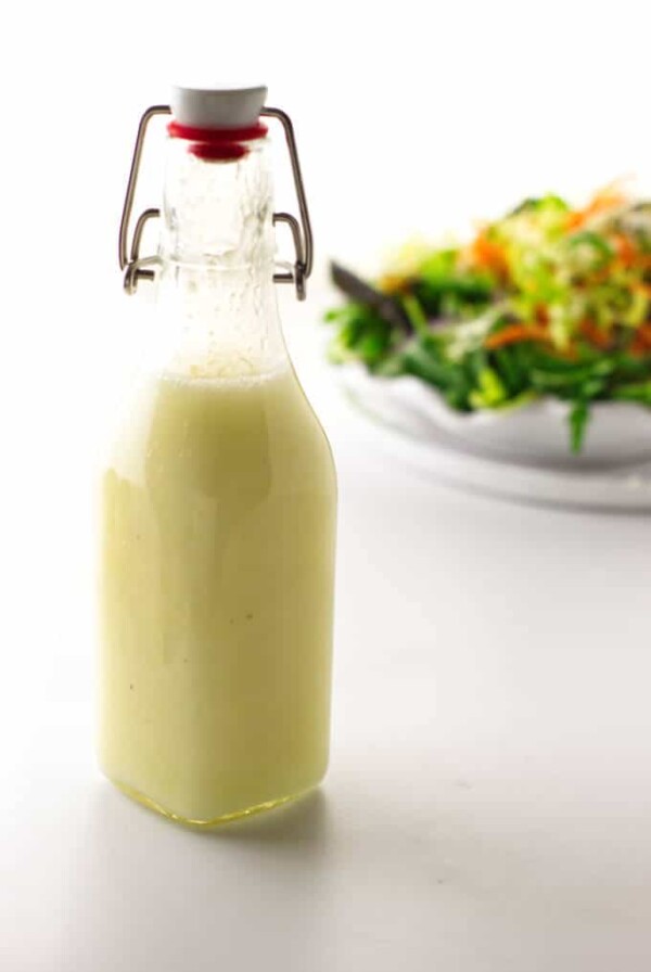 Bottle of preserved lemon vinaigrette and salad