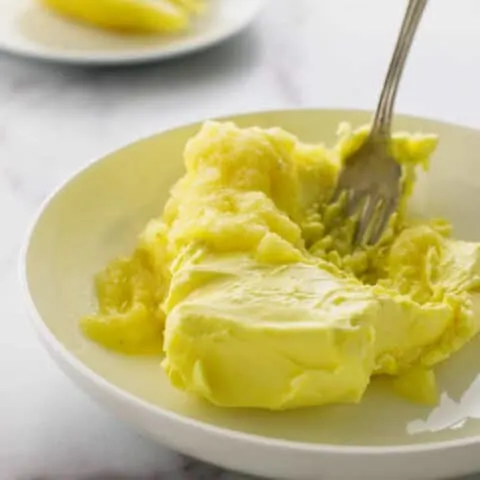 Pureed preserved lemons and butter with fork