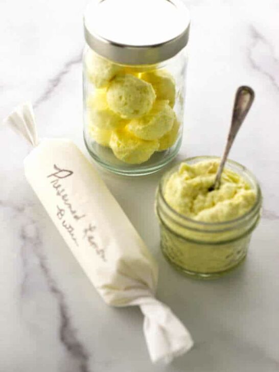 Jar of butter balls, jar of mashed butter and a parchment-wrapped butter log