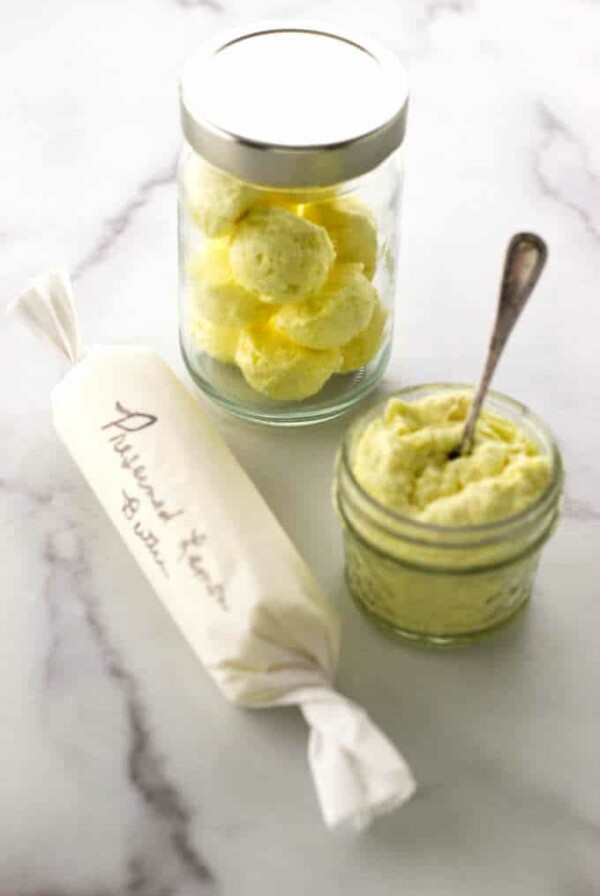 Jar of butter balls, jar of mashed butter and a parchment-wrapped butter log