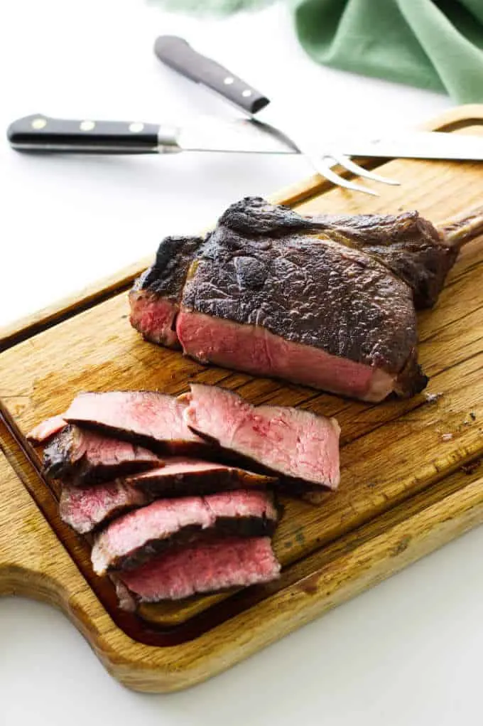 steak on cutting board with knife/fork