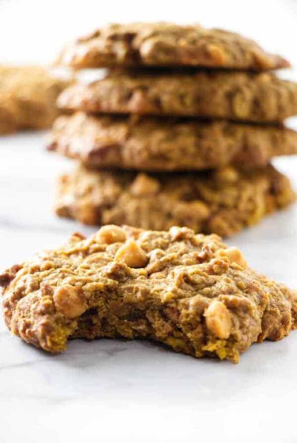 A pumpkin oatmeal cookie with a bite taken out of it