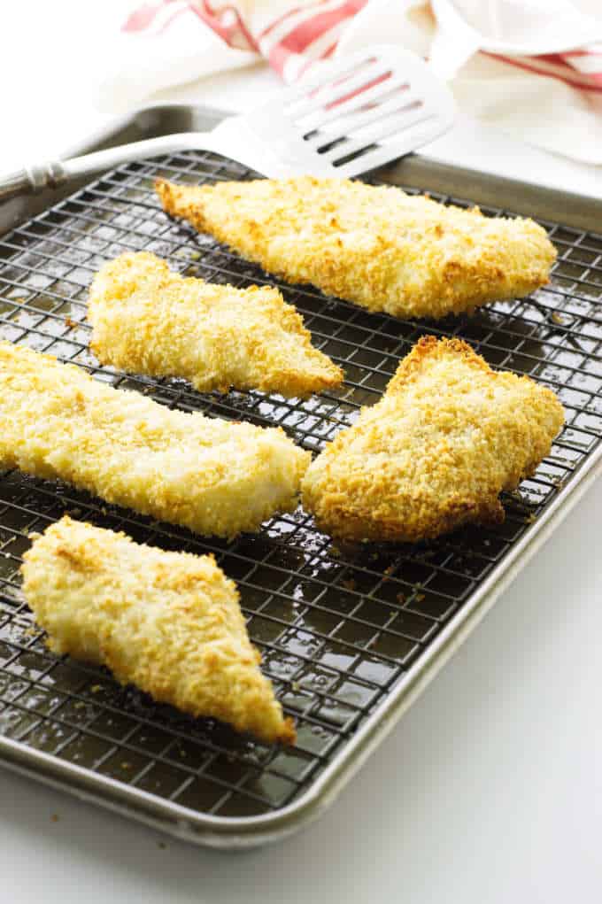 Breaded Cod Fish on rack with turner