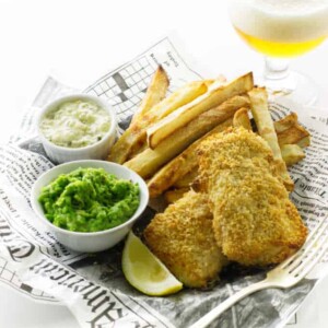 Oven fries, baked fish, mushy peas, tartar sauce and glass of beer