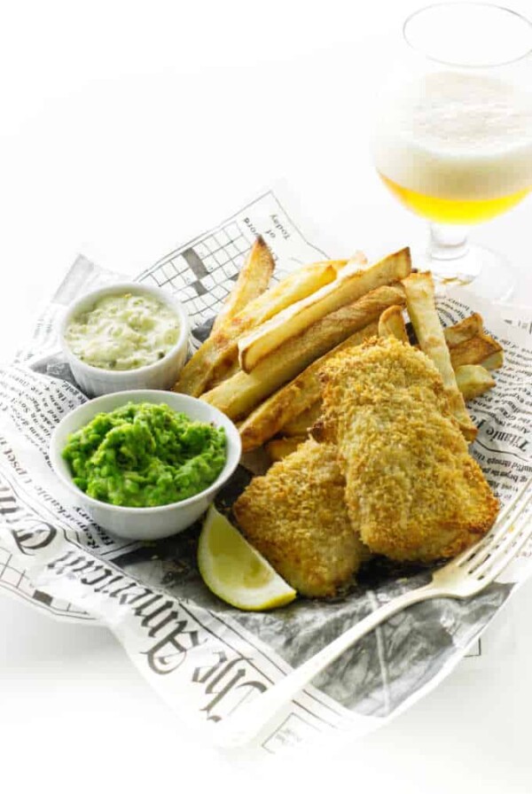 Oven fries, baked fish, mushy peas, tartar sauce and glass of beer