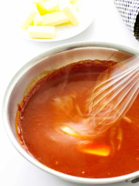 Buffalo sauce with butter being whisked in