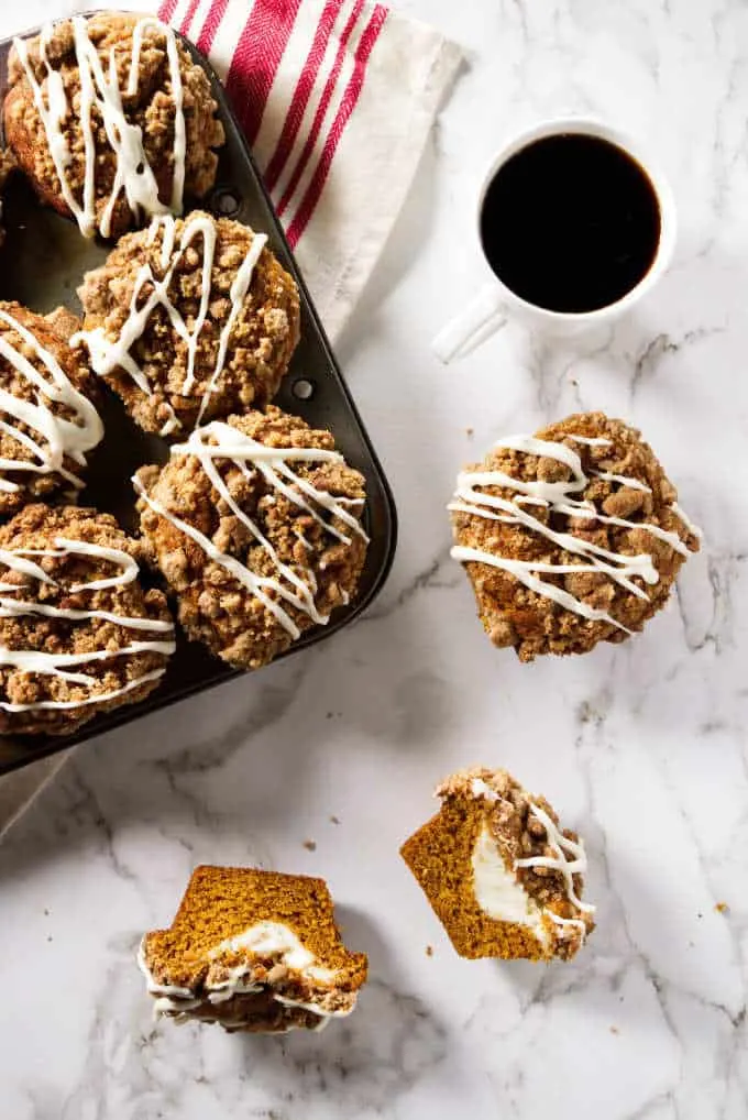 overhead shot of cheesecake stuffed pumpkin muffins