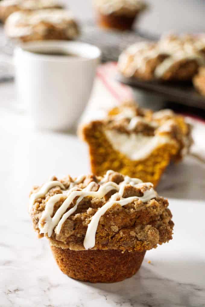 cheesecake stuffed pumpkin muffin with coffee in the background