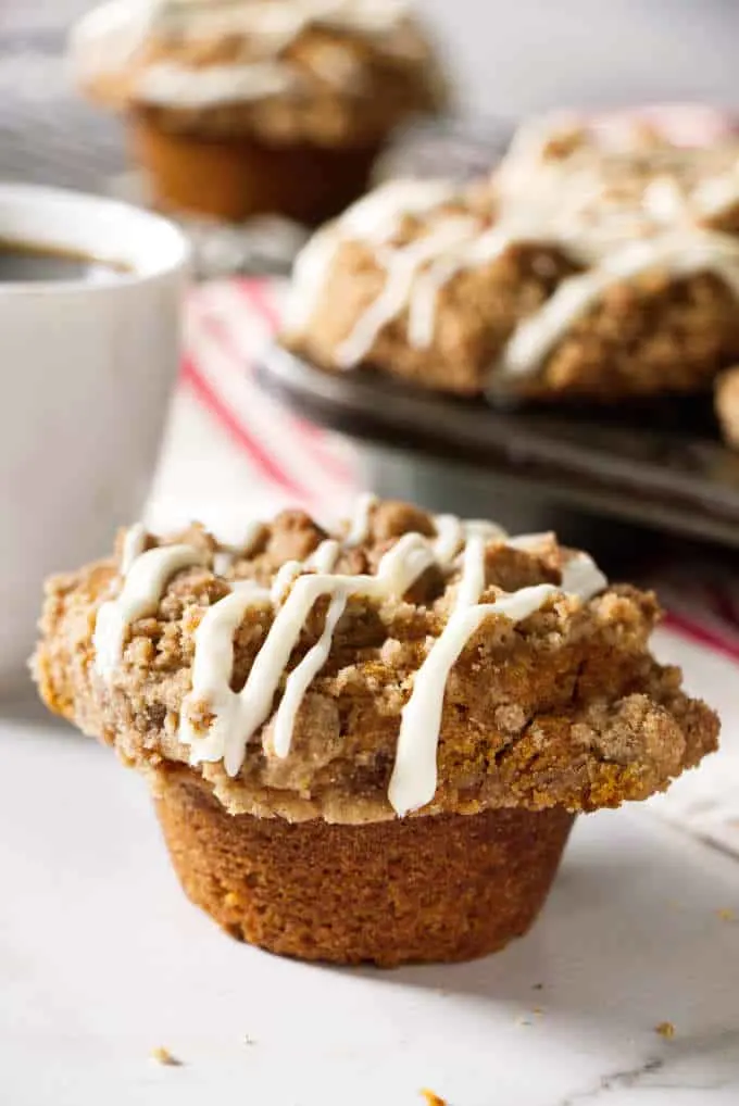 pumpkin muffin with a cup of coffee in the background