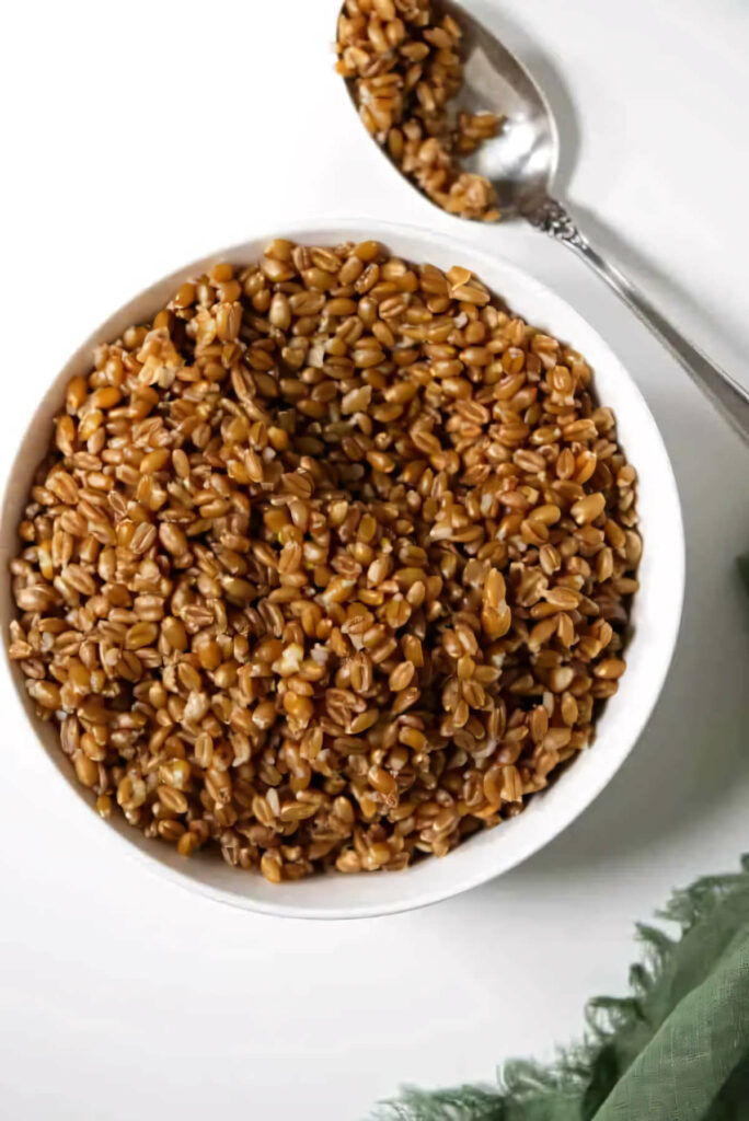 A bowl of instant pot farro with a spoon.