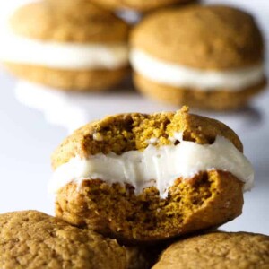 close up photo of pumpkin whoopie pies with cream cheese frosting