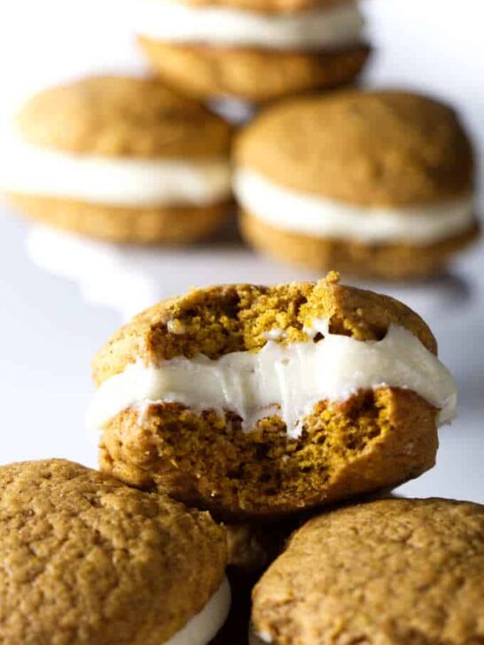 close up photo of pumpkin whoopie pies with cream cheese frosting