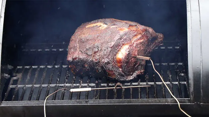 Smoked prime rib on a hot grill with a temperature probe