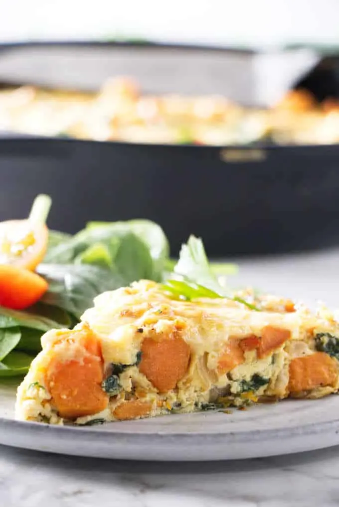 a slice of sweet potato frittata with a salad