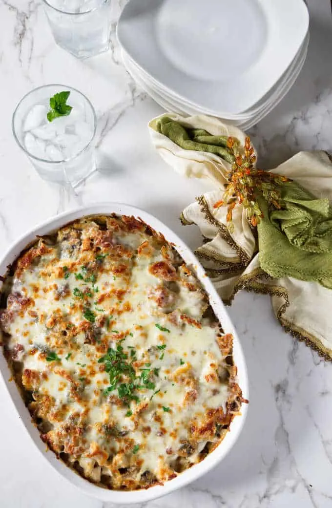 overhead shot of turkey pasta bake and some plates and glasses