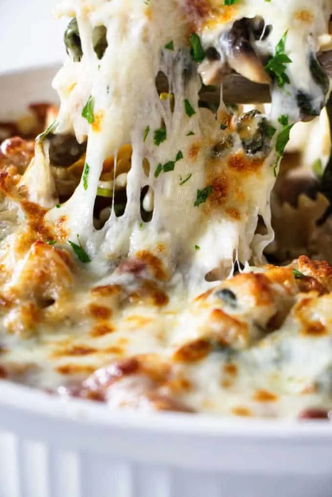 Turkey pasta bake being scooped out of a casserole dish