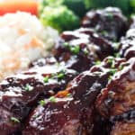 Country style pork ribs with broccoli in the background