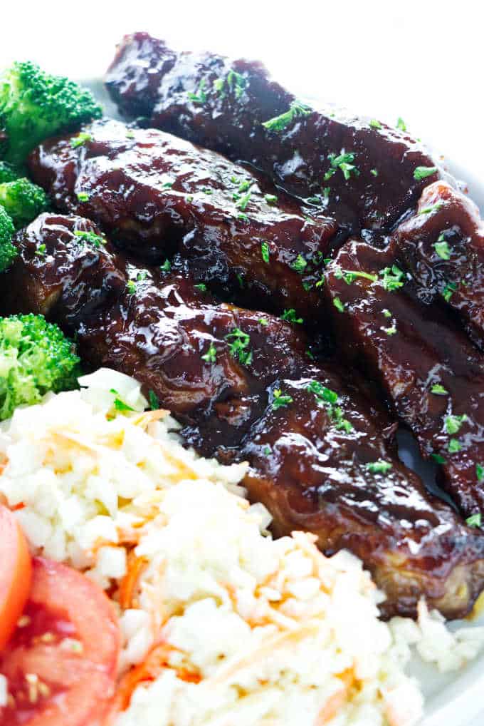 A plate of country style pork rib with coleslaw.