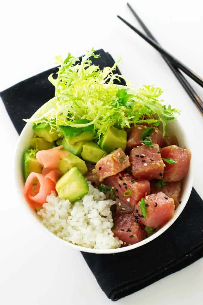 Overhead view of ahi tuna bowl on black napkin and chopsticks