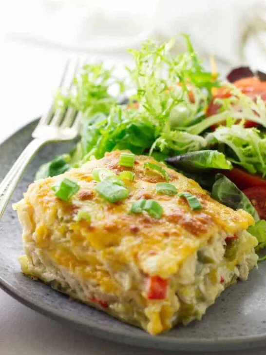 serving of chicken tortilla casserole on plate with salad and fork