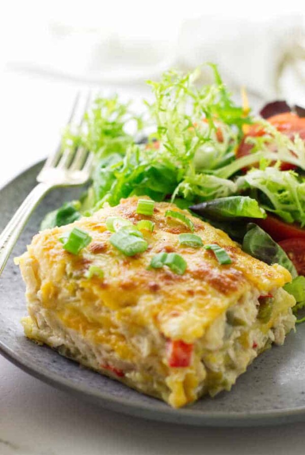 serving of chicken tortilla casserole on plate with salad and fork