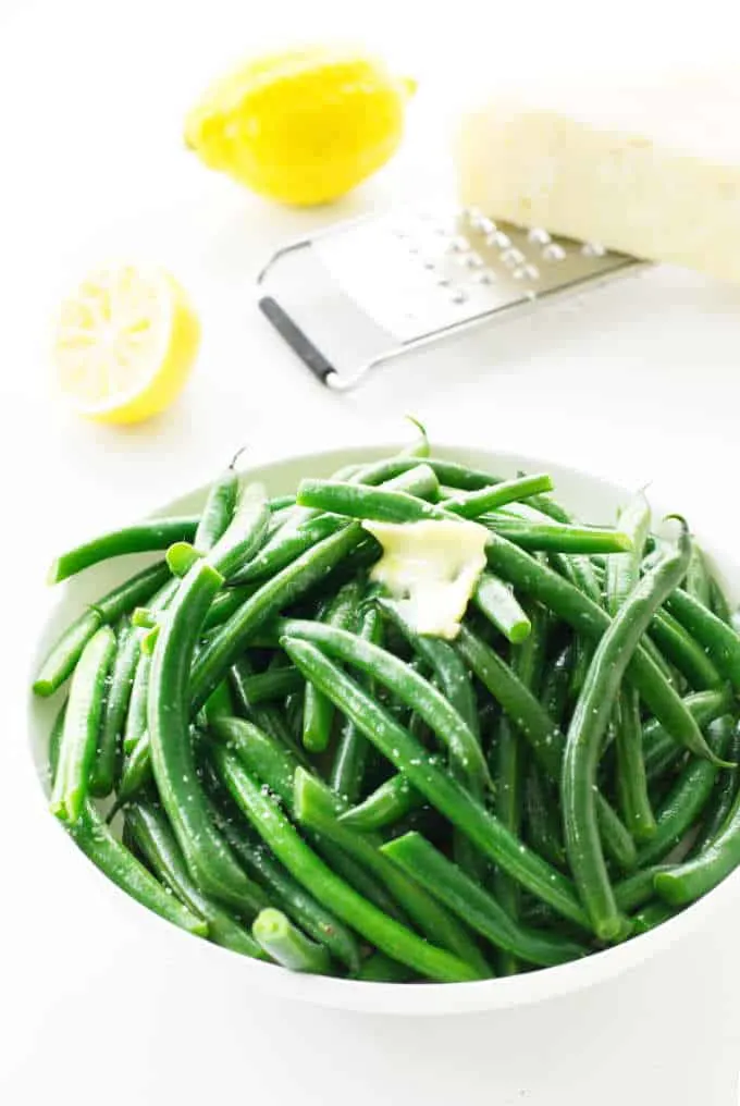 a serving dish with steamed green beans