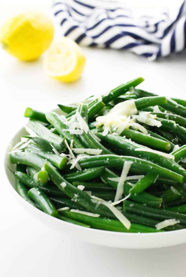 A bowl of steamed green beans with parmesan cheese