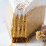 A slice of no bake pumpkin cheesecake with a bite taken