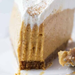 A slice of no bake pumpkin cheesecake with a bite taken