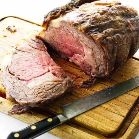 rib roast on cutting board with knife