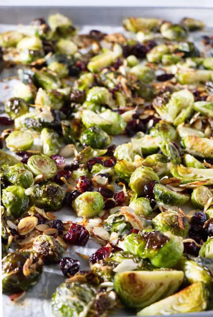 A sheet pan of roasted Brussels sprouts with parmesan, cranberries, and almonds