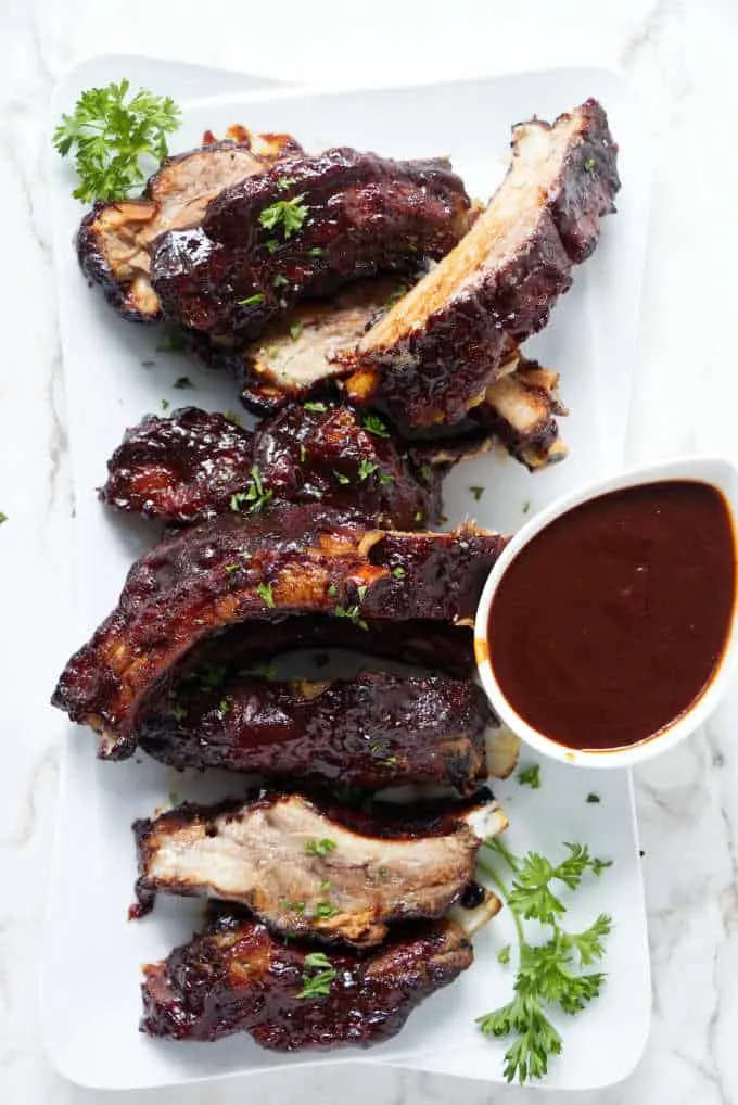 Overhead photo of baby back ribs and barbecue sauce