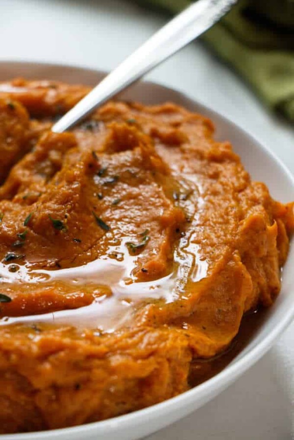 Close up photo of instant pot mashed sweet potatoes with a drizzle of butter