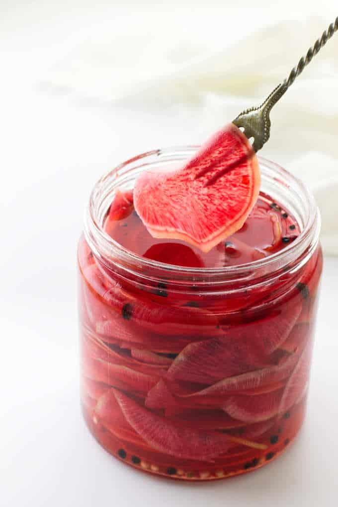 Jar of pickled watermelon radish and serving fork