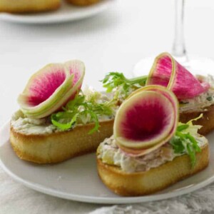 Close up photo of watermelon radish and goat cheese crostini