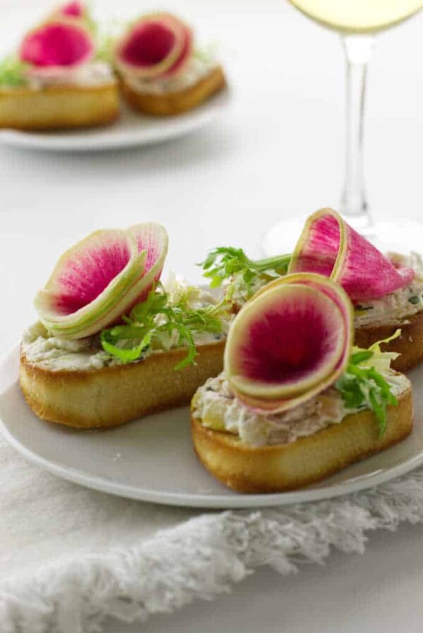 Close up photo of watermelon radish and goat cheese crostini