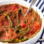 instant pot Lebanese green beans in a serving dish with a spoon