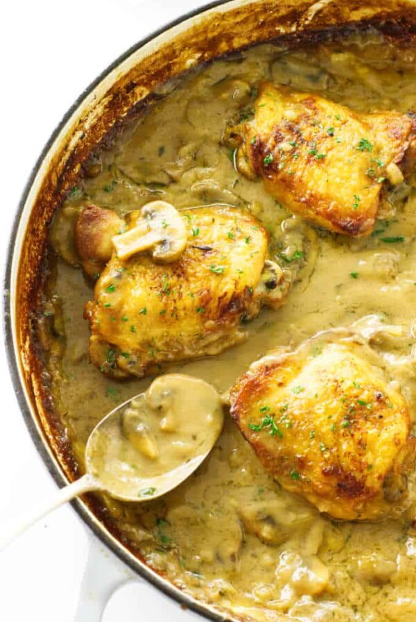 Close up view of chicken thighs in mushroom cream sauce