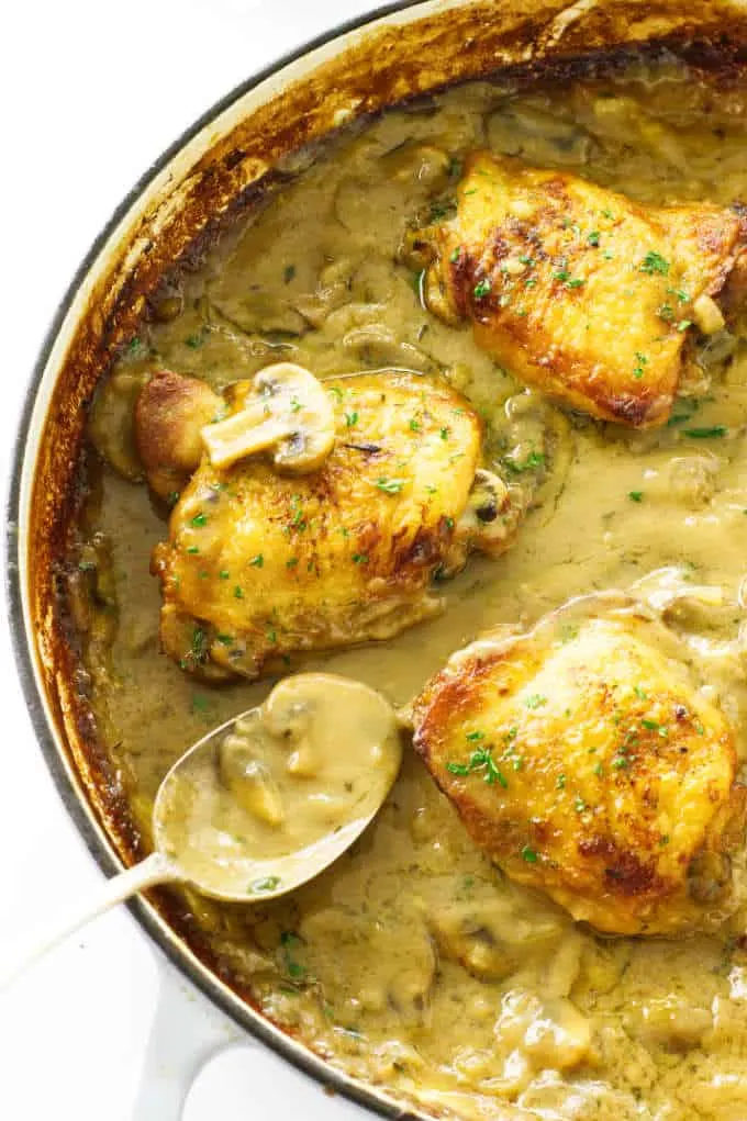 Close up view of chicken thighs in mushroom cream sauce