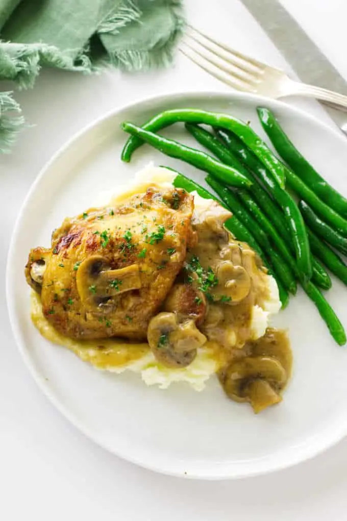 Overhead view of chicken and mushroom cream sauce on top of mashed potatoes