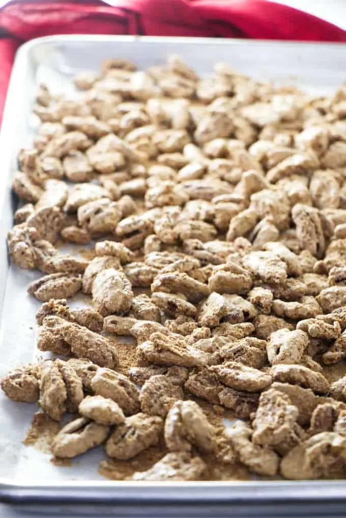 A sheet pan of freshly roasted cinnamon sugar candied pecans.