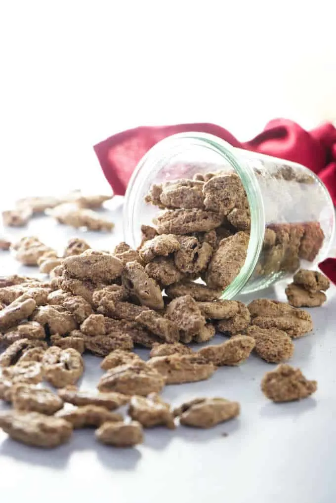 Cinnamon sugar candied pecans with a red napkin in the background.