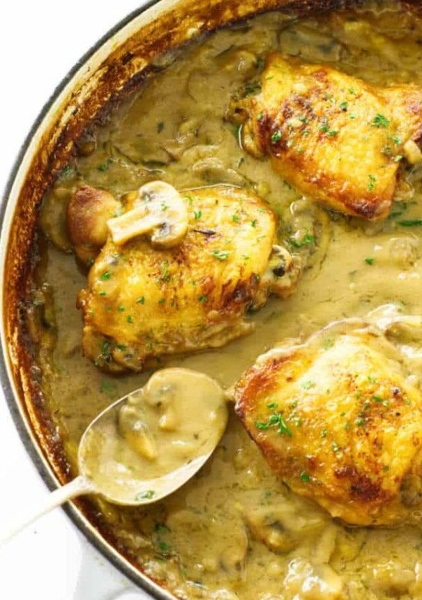 Close up view of chicken thighs in mushroom cream sauce