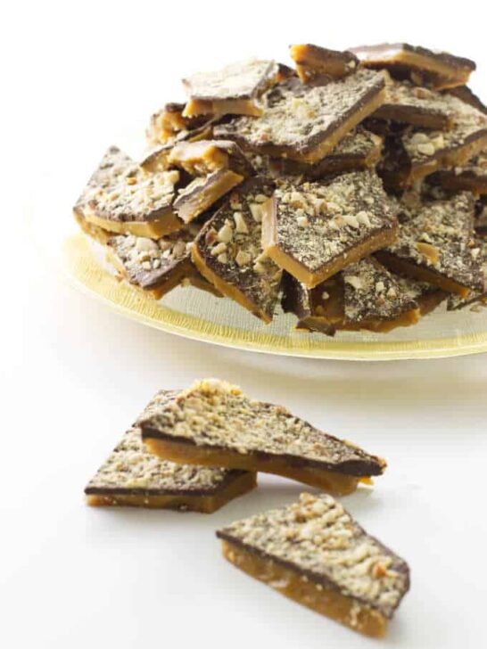 Plate of English toffee with 3 pieces in foreground