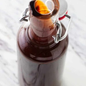 Homemade chocolate syrup in a tall bottle.