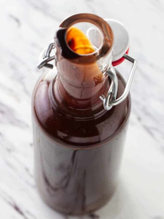 Homemade chocolate syrup in a tall bottle.