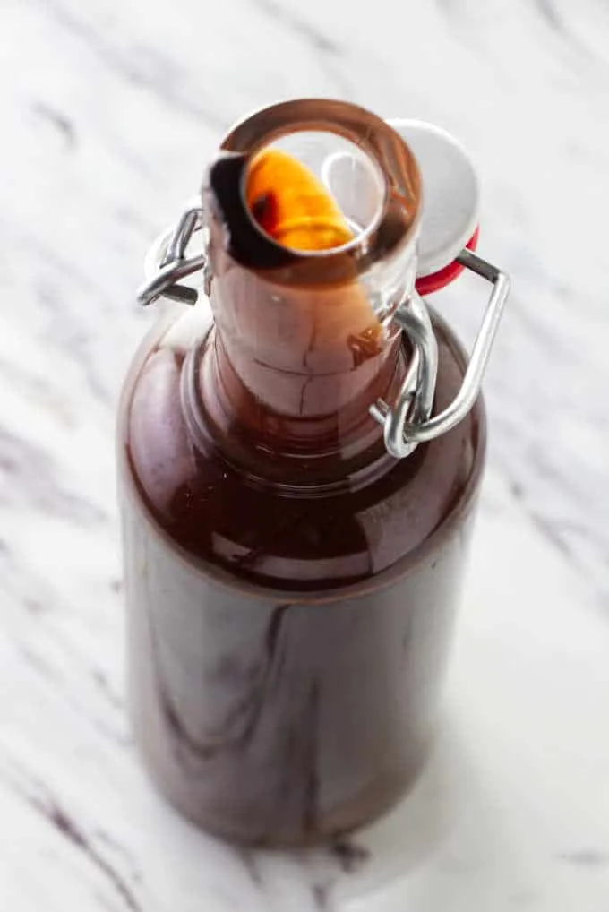 Homemade chocolate syrup in a tall bottle.